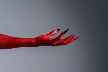 Scary female monster hands halloween character red color isolated background. © Phushutter