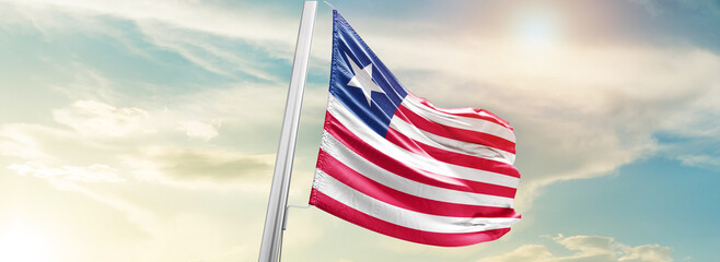 Liberia national flag cloth fabric waving on the sky - Image