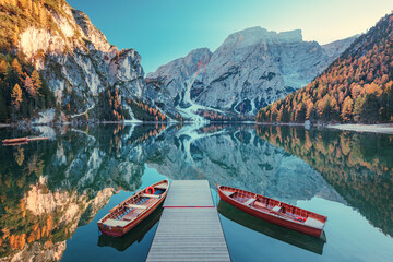 Boats on the Braies Lake ( Pragser Wildsee ) in Dolomites mountains, Sudtirol, Italy. Alps nature landscape. - obrazy, fototapety, plakaty