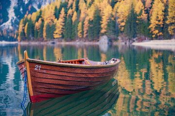 Boats on the Braies Lake ( Pragser Wildsee ) in Dolomites mountains, Sudtirol, Italy. Alps nature landscape.
