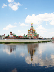 Fototapeta premium Cathedral of the Annunciation of the Blessed Virgin Mary on waterfront of Malaya Kokshaga river in Yoshkar-ola city on sunny summer day