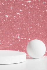 Geometric white podium on a pink shiny sparkling background for the presentation of a cosmetic...