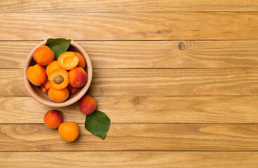 Composition with ripe apricots on wooden background, top view