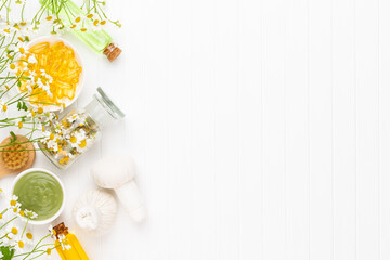 Spa still life with homemade cosmetic chamomile, herbal oil, soap, sea salt.