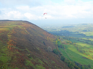 Paragliders flying above the ridge at Pandy, Wales	