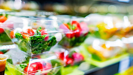 Vegetable salads displayed in a commercial refriger