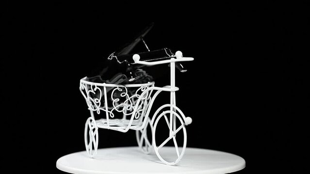 footage of miniature bicycle piano dark background 