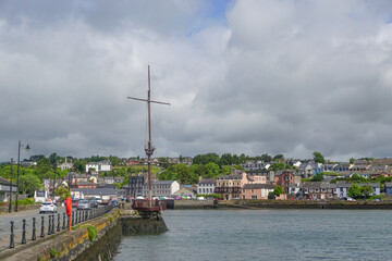 Fototapeta na wymiar Kinsale, Co. Cork, Ireland: Replica mast from a Spanish galleon on the quayside overlooking Kinsale Harbour. Erected in 2001 on the 400th anniversary of the Battle of Kinsale (1601).