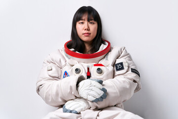 Asian cosmonaut looking at camera in studio