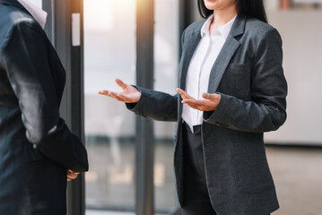 Group business people meet and discuss chart and point at chart Company report share marketing in the office. Business team stand to discuss and work together at the office.