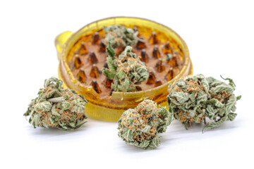 marijuana bud grinder and dried weed isolated on a white background