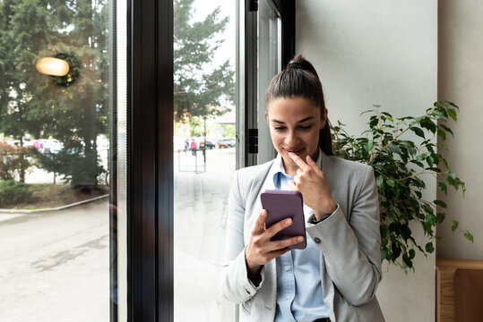 Young Woman Successful Real Estate Agent Making Appointment With Potential Client Who Is Interested For Apartment To Rent. Rental Agency Worker Selling Over The Phone Home To A Buyer.