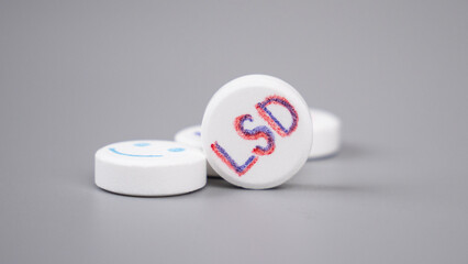lsd pills closeup on gray background, lysergic acid.