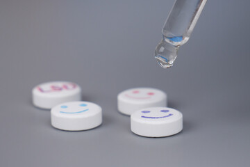 pipette and lsd pills closeup,medicinal lysergic acid diethylamide