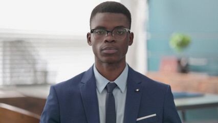 Serious Young African Businessman Looking at the Camera