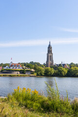 Fototapeta na wymiar Skyline of Rhenen with Cunerakerk and restaurant Province of Utrecht. The Lower Rhine is very narrow with extremely low water as result of the hit wave in the summer of 2022