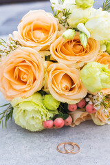 Wedding, bridal bouquet, wedding rings lie near the bridal bouquet