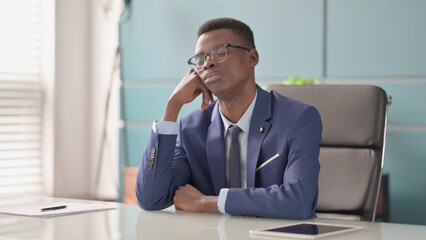 Sleepy Young African Businessman Taking Nap While Sitting in Office