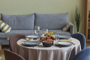 Horizontal image of table with holiday dinner standing in living room