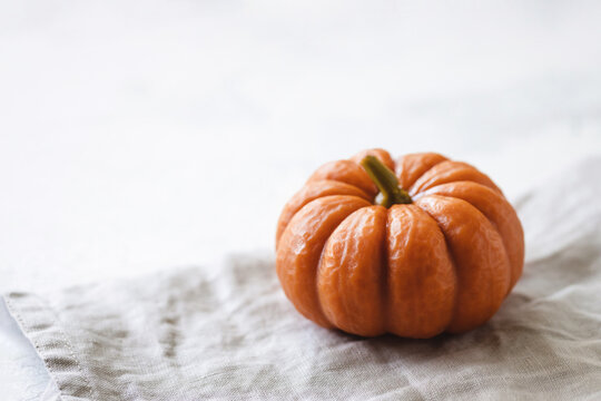 Pumpkin on a linen cloth on the table.