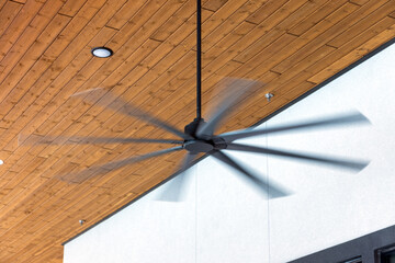 HVLS ceiling fan big fans for hot air cooling. Large ceiling fans for open air building with brown...