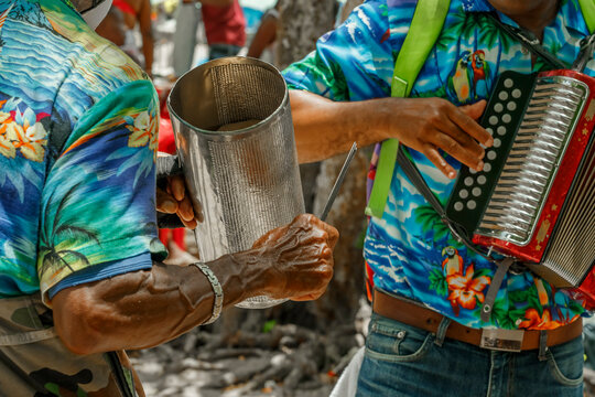 Dominican Republic. Beach musicians. Merengue music. Playing the accordion and guiro.