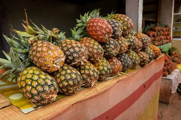 Pile of fresh pineapples on display at street market in Madagascar