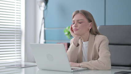 Tired Woman Sleeping While Sitting in Office