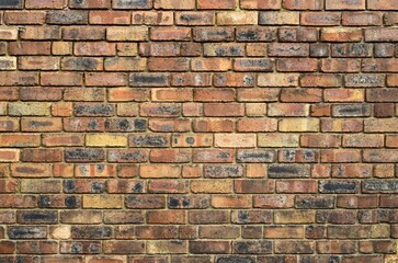Fototapeta premium Old multicolored brick wall background.