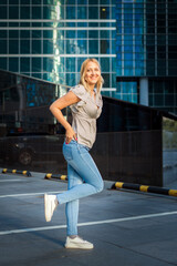 Fototapeta na wymiar Stylish beautiful Blonde Posing City, a great design for any purpose. An attractive elegant woman in jeans.