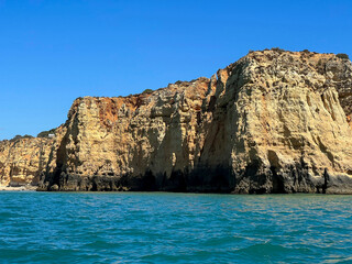 Fototapeta premium The cliffs of the Ponta da Piedade headland is one of the finest natural features of the Algarve. This dramatic limestone coastline is formed of sea pillars, fragile rock arches and hidden grottos.