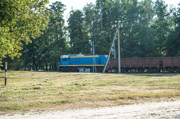 Train locomotive rides on rails. Diesel freight train on railroad in motion. The head of a heavy diesel tractor locomotive for transporting train wagons