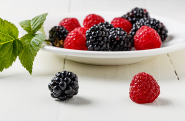 Fresh and organic berries of blackberries and raspberries on the table