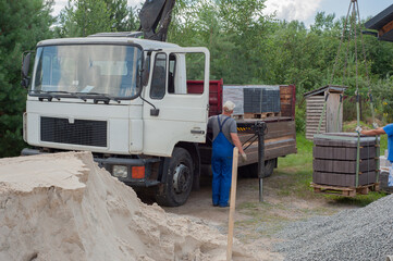 Fototapeta premium Dump trucks carrying good filling a field, giving rise to a fine soil. Preparation and construction.