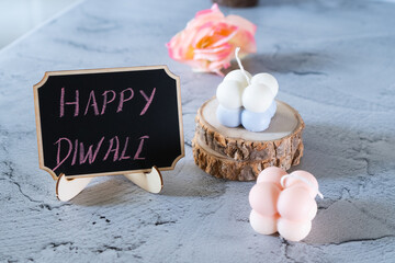 small bubble candles and blackboard with happy diwali written in chalk perfect card for diwali...