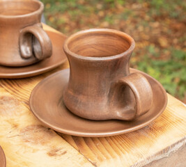 Clay mug and a clay plate on a table