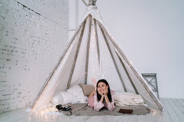 Asian woman lying and resting in wigwam tent © BullRun