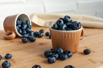 Fresh blueberries in terracotta cups. Coffee cups. Selective focus. simple composition