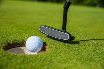 golf club and ball on the green