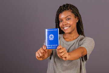 Young afro brazilian woman holding work card and social security. Official document, Human...