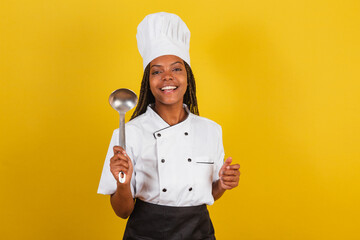 Young afro brazilian woman, chef cook, holding cooking ladle, kitchen accessory.