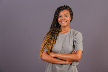 Young afro woman brazilian, arms crossed, happy, smiling. trusting.