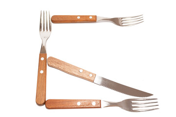 3 forks and 1 knife with wooden handle making the letter G on a white background