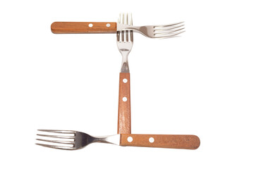 3 forks with wooden handles making the letter I on a white background