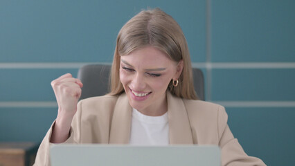 Close Up of Businesswoman Celebrating Success while using Laptop in Office