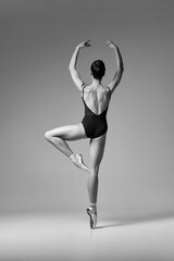 Back of young beautiful ballerina in point shoes black and white.  Art, motion, action, inspiration...