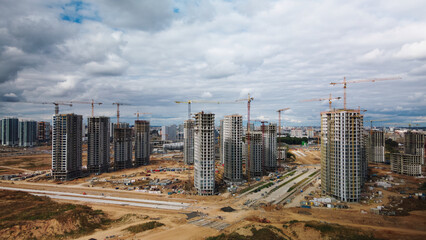 Construction site of a new city block. Construction of multi-storey buildings. Aerial photography.