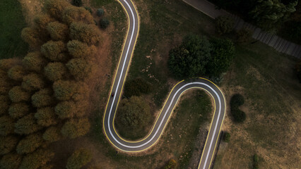 Winding bike path in the city park. City park at dawn. Aerial photography.