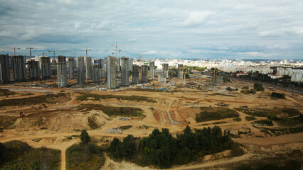 Fototapeta premium Construction site of a new city block. Construction of multi-storey buildings. Aerial photography.