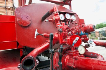 Elements of a vintage fire truck. The car is painted red. Close-up.